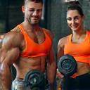 Trainer and client lifting weights
