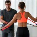 Trainer assisting client with rehabilitation exercise